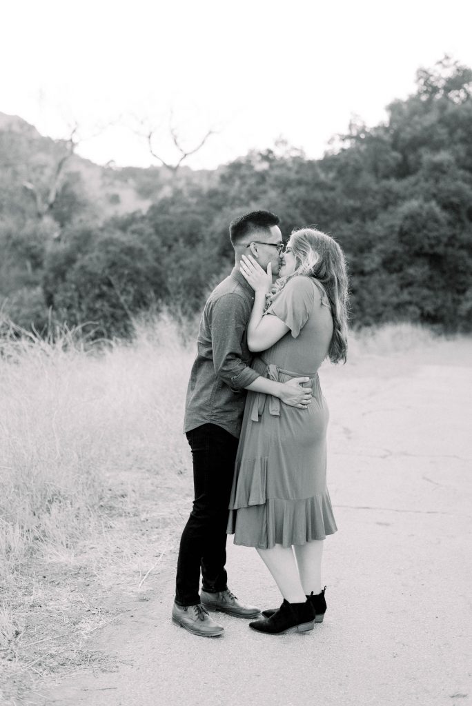 Engaged couple kissing in Malibu Creek State Park