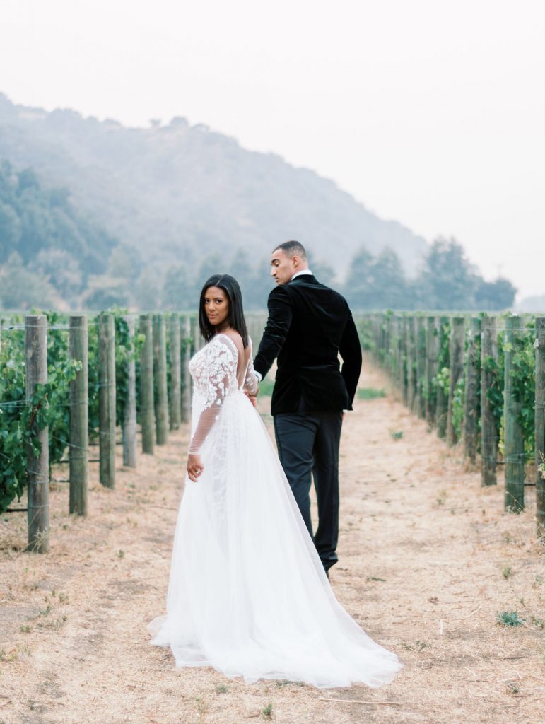 bride and groom holding hands walking at Lavender Oak Vineyard